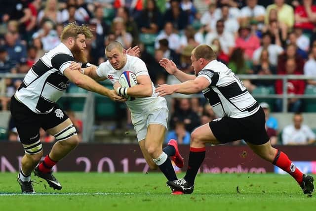 Mike Brown is tackled by Gillian Galan and WP Nel, right, during the  match between England and the Barbarians last month. Nels contribution off the bench was enough to convince Gregor Townsend he can play against Italy. Picture: Tony Marshall/ RFU