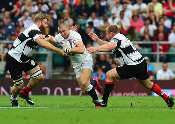 Mike Brown is tackled by Gillian Galan and WP Nel, right, during the  match between England and the Barbarians last month. Nels contribution off the bench was enough to convince Gregor Townsend he can play against Italy. Picture: Tony Marshall/ RFU