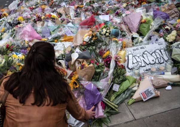 A woman lays flowers near the scene on London Bridge, where eight people were killed and at least 48 injured. Picture: Getty Images