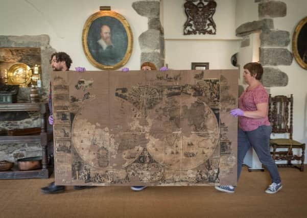 Staff at Castle Fraser move the 17th Century "chimney map" into place after it was returned from to Aberdeenshire from Edinburgh. PIC: Newsline.