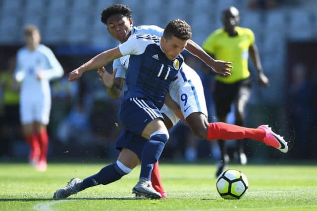 Scotland's Adam Frizzell vies with England's Demetri Mitchell at the Toulon tournament semi-final at the Parsemain Stadium in Fos-sur-Mer. Picture: Anne-Christine Poujoulat/AFP/Getty Images