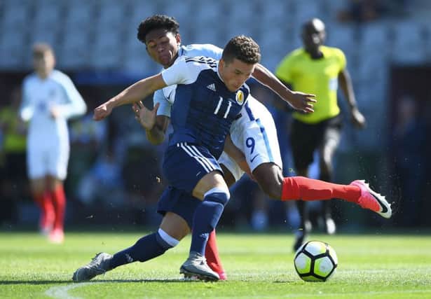 Scotland's Adam Frizzell vies with England's Demetri Mitchell at the Toulon tournament semi-final at the Parsemain Stadium in Fos-sur-Mer. Picture: Anne-Christine Poujoulat/AFP/Getty Images