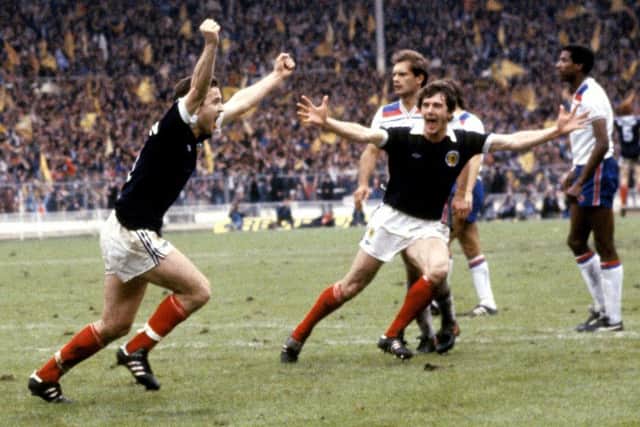 Scotland's John Robertson celebrates his penalty winner against England in 1981 with teammate Ray Stewart. Picture: SNS