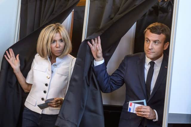 French President Emmanuel Macron and his wife Brigitte Macron leave the voting booth at a polling station to vote during the first round of the French legislative election in Le Touquet. Picture: CHRISTOPHE PETIT TESSON/AFP/Getty Images