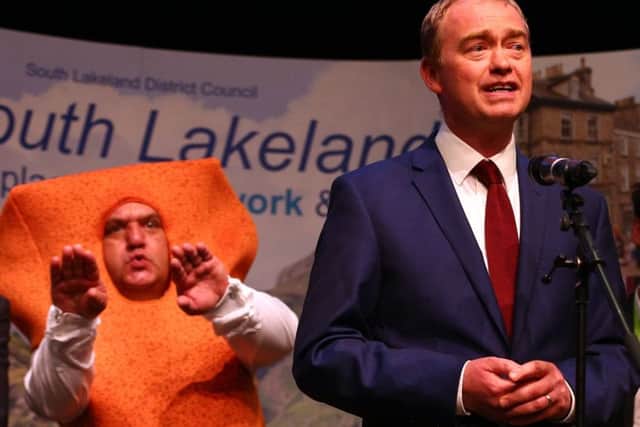 Leader of the Liberal democrats Tim Farron stands in front of Independent candidate Mr Fishfinger following the announcement of the results and that he would keep his seat at the Westmoorland and Lonsdale constituency count at Kendal Leisure Centre on June 9, 2017 in Kendal, United Kingdom. After a snap election was called, the United Kingdom went to the polls yesterday following a closely fought election. (Photo by Dave Thompson/Getty Images)