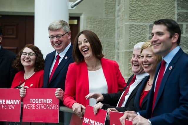 A delighted Kezia Dugdale celebrates with the six new Scottish Labour MPs, from left, Ged Killen, Danielle Rowley, Martin Whitfield, Hugh Gaffney , Lesley Laird and Paul Sweeney, at Rutherglen Town Hall today. Picture: John Devlin
