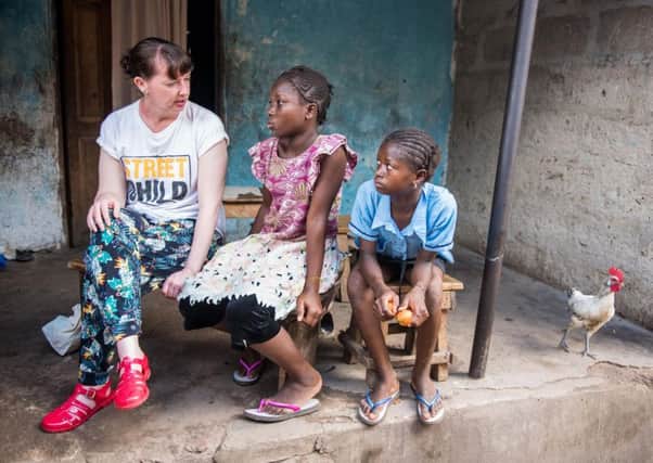 Pauline Cafferkey with orphans of Ebola who are being helped by the charity in Sierra Leone. Picture: PA