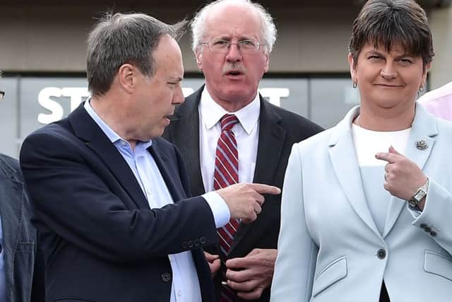 DUP deputy leader Nigel Dodds (L) points to DUP leader and Northern Ireland former First Minister Arlene Foster (R). Jim Shannon is in the centre. (Photo by Charles McQuillan/Getty Images)