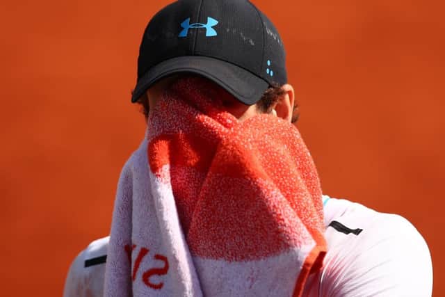 Andy Murray wipes his face with a towel during his semi-final defeat by Stan Wawrinka. Picture: Clive Brunskill/Getty Images