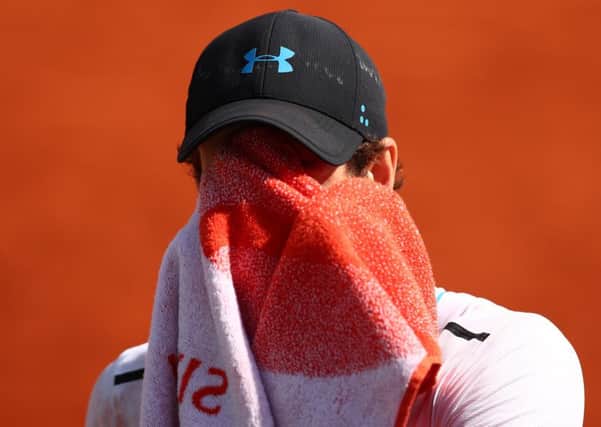 Andy Murray wipes his face with a towel during his semi-final defeat by Stan Wawrinka. Picture: Clive Brunskill/Getty Images