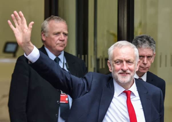 Jeremy Corbyn waves as he leaves the Labour party headquarters in London. Picture: SWNS