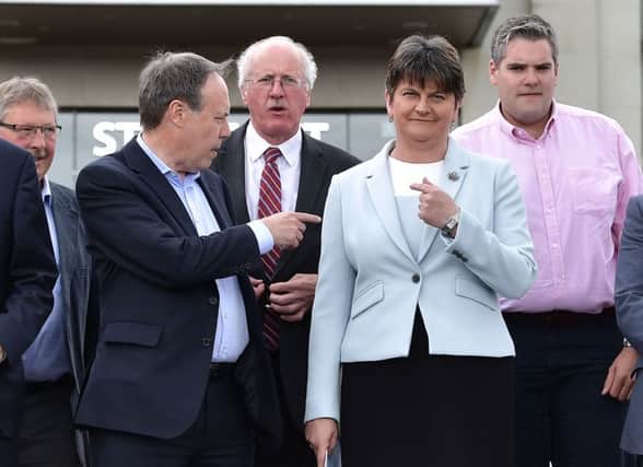 DUP deputy leader Nigel Dodds (L) points to leader and Northern Ireland former First Minister Arlene Foster as they hold a photocall with their newly elected candidates. Picture: Charles McQuillan/Getty Images