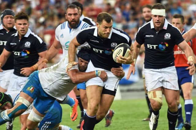 Tim Visser attempts to evade Italian tackle in a strong win. Picture: ROSLAN RAHMAN/AFP/Getty Images