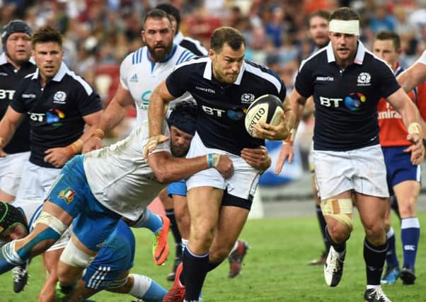 Tim Visser attempts to evade Italian tackle in a strong win. Picture: ROSLAN RAHMAN/AFP/Getty Images