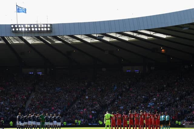 Fans, players and officials take part in a minute's silence for the recent terror attacks victims.  Picture: Mike Hewitt/Getty Images