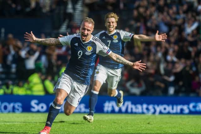 Leigh Griffith celebrates his second goal, but the joy was ended by Harry Kane, left. Main photograph: John Devlin