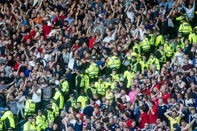 Agony and ecstasy: The home fans are stunned as England celebrate their late leveller.
Photograph: John Devlin