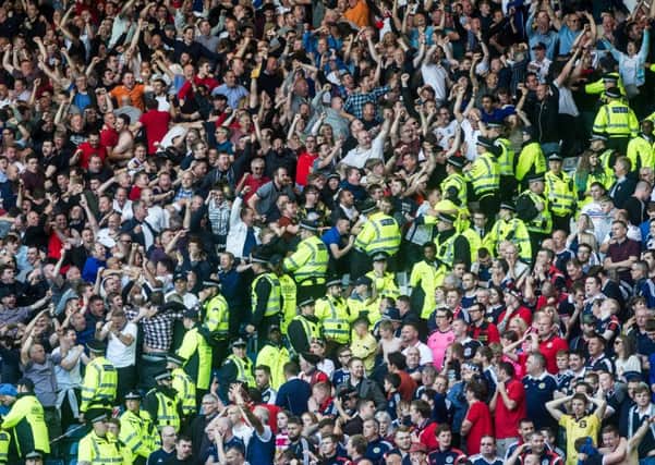 Agony and ecstasy: The home fans are stunned as England celebrate their late leveller. 
Photograph: John Devlin