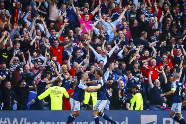 Leigh Griffiths celebrates after he scores a free kick to put his ahead. Picture: SNS/Roddy Scott