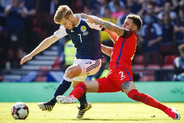 Scotland's Stuart Armstrong evades a tackle from England's Kyle Walker at Hampden.