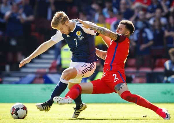 Scotland's Stuart Armstrong evades a tackle from England's Kyle Walker at Hampden.