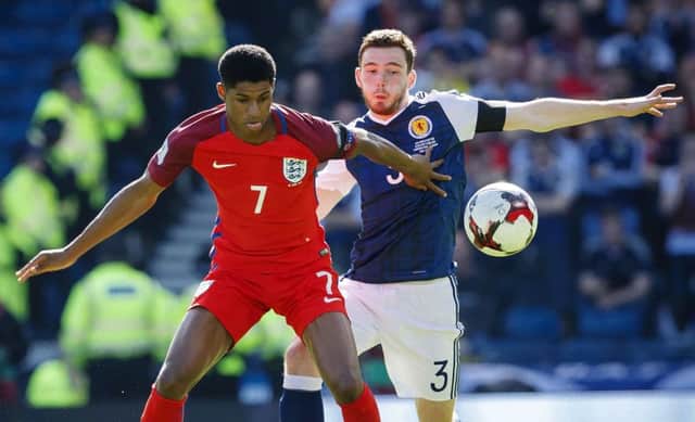 Andrew Robertson battling with England's Marcus Rashford. Picture: SNS/Roddy Scott