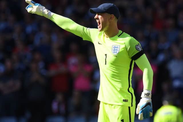England goalkeeper Joe Hart needs a cap to shield his eyes at a sun-drenched Hampden. Picture: Craig Williamson/SNS