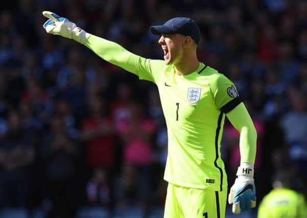 England goalkeeper Joe Hart needs a cap to shield his eyes at a sun-drenched Hampden. Picture: Craig Williamson/SNS