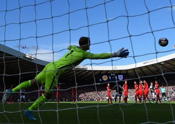 Leigh Griffiths curls a wonderful free-kick past Joe Hart to give Scotland a 2-1 lead against England. Picture: Shaun Botterill/Getty Images
