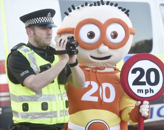 Edinburgh Council 20mph mascot The Reducer with PC Ben Wray. Picture: Greg Macvean