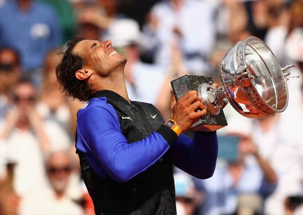 An emotional Rafael Nadal celebrates with the trophy after his crushing win over Stan Wawrinka in the French Open final: Picture Clive Brunskill/Getty