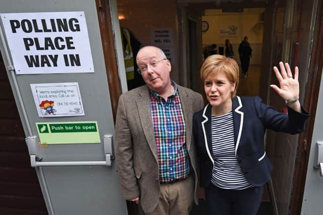 SNP Leader Nicola Sturgeon exits after casting her vote in the general election with her husband Peter Murrel at Broomhouse Community Hall in Glasgow, Scotland. Picture: Jeff J Mitchell/Getty Images