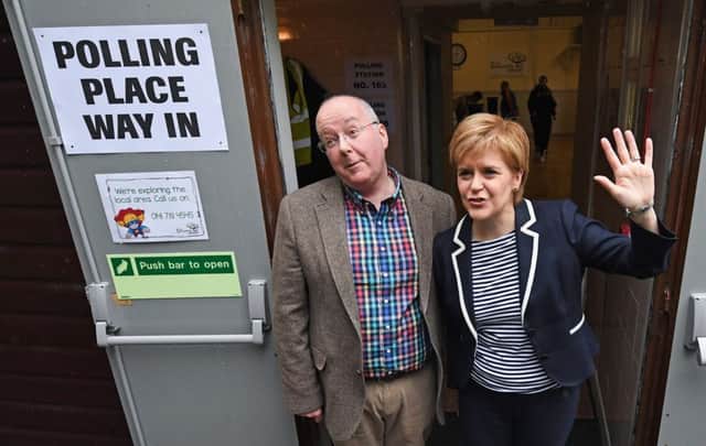 SNP Leader Nicola Sturgeon exits after casting her vote in the general election with her husband Peter Murrel at Broomhouse Community Hall in Glasgow, Scotland. Picture: Jeff J Mitchell/Getty Images