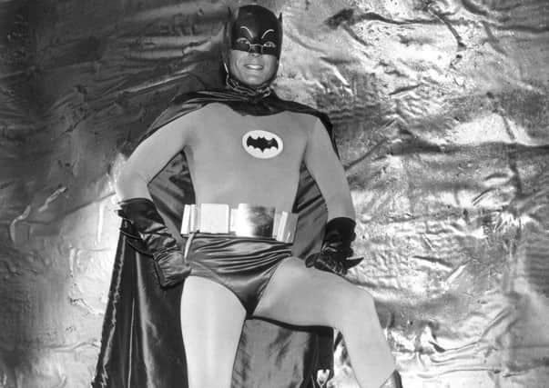 1966: Actor Adam West wears his Batman costume in the Batcave in a full-length promotional portrait for the television series, 'Batman'. (Photo by Hulton Archive/Getty Images)