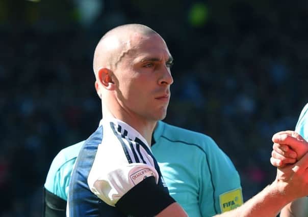 Scotland captain Scott Brown shakes hands with England captain Harry Kane. Picture: SNS/Craig Williamson