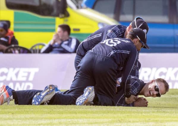 Scotland's Con de Lange is congratulated by team-mates asfter his superb diving catch to remove Namibia batsman Craig Williams. Picture: Donald Macleod