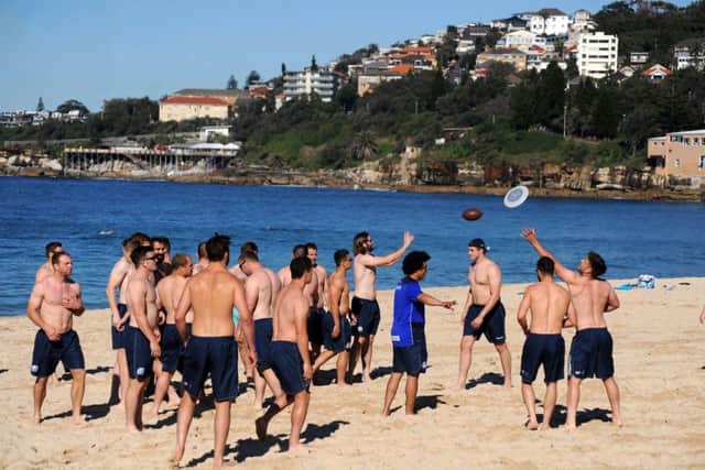 Scotland players stretch off on Coogee beach at the start a recovery session. Picture: Fotosport/David Gibson