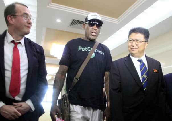 Dennis Rodman is greeted by vice minister of sports Son Kwang Ho, right, upon his arrival in Pyongyang. Picture: AP