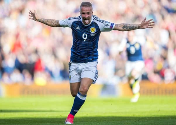 Leigh Griffiths celebrates his first free-kick against England. Picture: SNS/Bill Murray