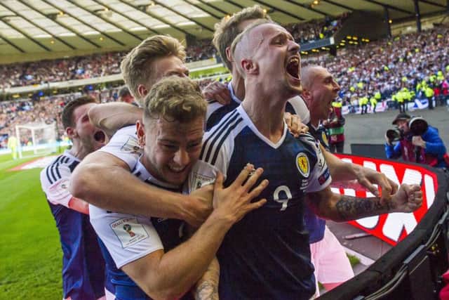 Scotland players go wild after Griffiths scores against England. Picture: SNS/Bill Murray
