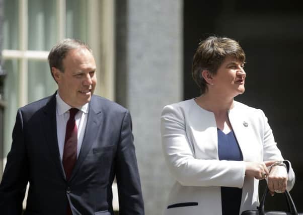 DUP leader Arlene Foster and deputy leader Nigel Dodds arriving at 10 Downing Street for talks. Picture: PA