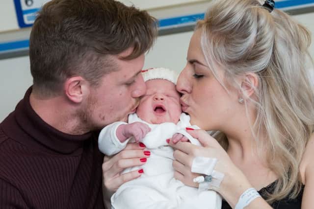 Sam Skinner (right) and Wayne Archibald welcome their baby Noel to the world. The birthrate in Scotland has fallen to a 14-year low. Picture: Ian Georgeson