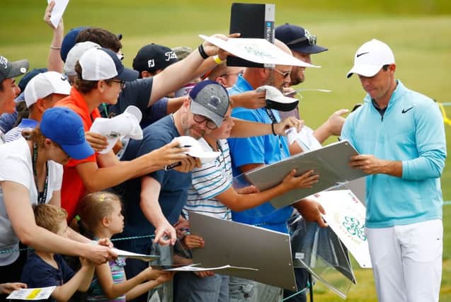 Rory McIlroy, pictured signing autographs at the US Open at Erin Hills, will be a big crowd puller at Dundonald Links next month. Picture: Getty Images
