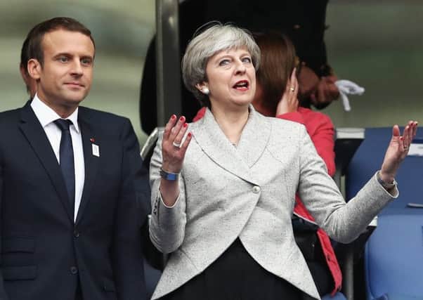 Emmanuel Macron, left, with Theresa May. Picture: Getty Images
