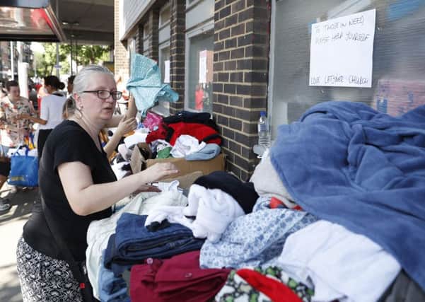 Clothes are offered to those affected by the fire that ripped through Grenfell Tower. Picture: AFP Photo / Getty Images