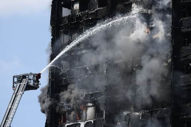 Fire fighters drench the burning 24 storey residential Grenfell Tower block in Latimer Road, West London.  (Photo by Carl Court/Getty Images)