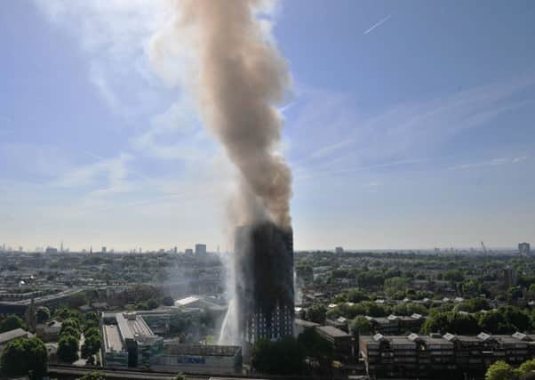 Smoke billows from a fire that has engulfed the 24-storey Grenfell Tower in west London. Picture: Victoria Jones/PA Wire