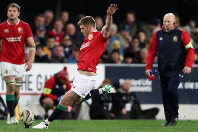 Owen Farrell takes a penalty, watched by Lions kicking coach Neil Jenkin. Picture: Getty.