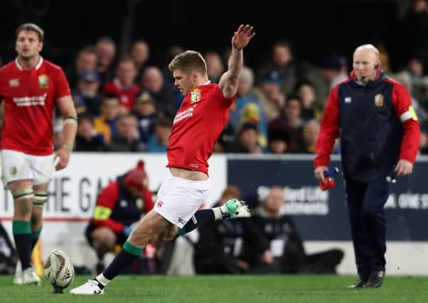 Owen Farrell takes a penalty, watched by Lions kicking coach Neil Jenkin. Picture: Getty.