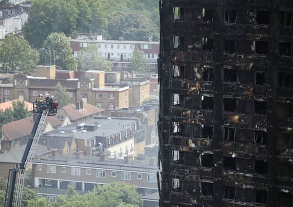 Firefighters inspect the blackened exterior of Grenfell Tower(Photo by Dan Kitwood/Getty Images)